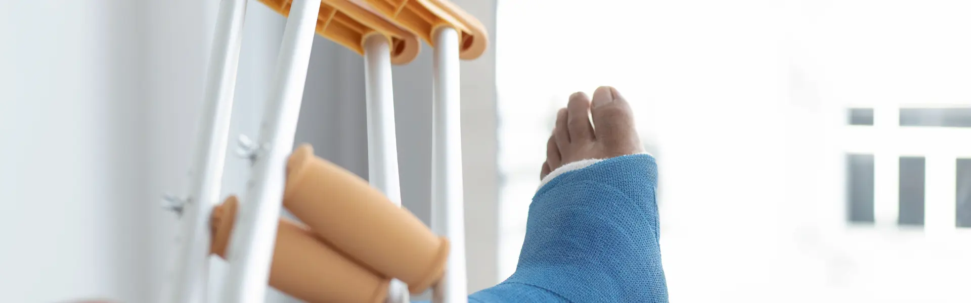 A leg in a cast with crutches