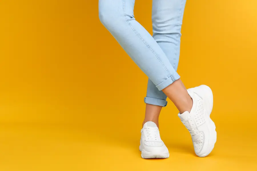 Legs with white shoes on yellow background | Capital Surgical Ankle Surgery Boise