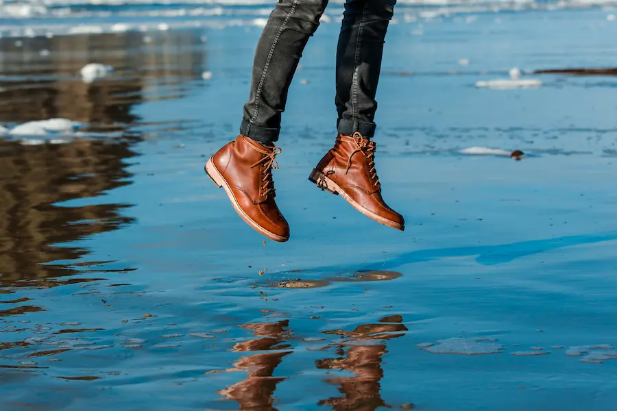 Boot clad legs jumping over water | Capital Surgical Ankle Surgery Boise