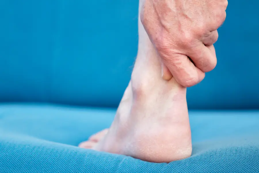 Person holding their ankle tendon | Capital Surgical Tendonitis Surgery Boise